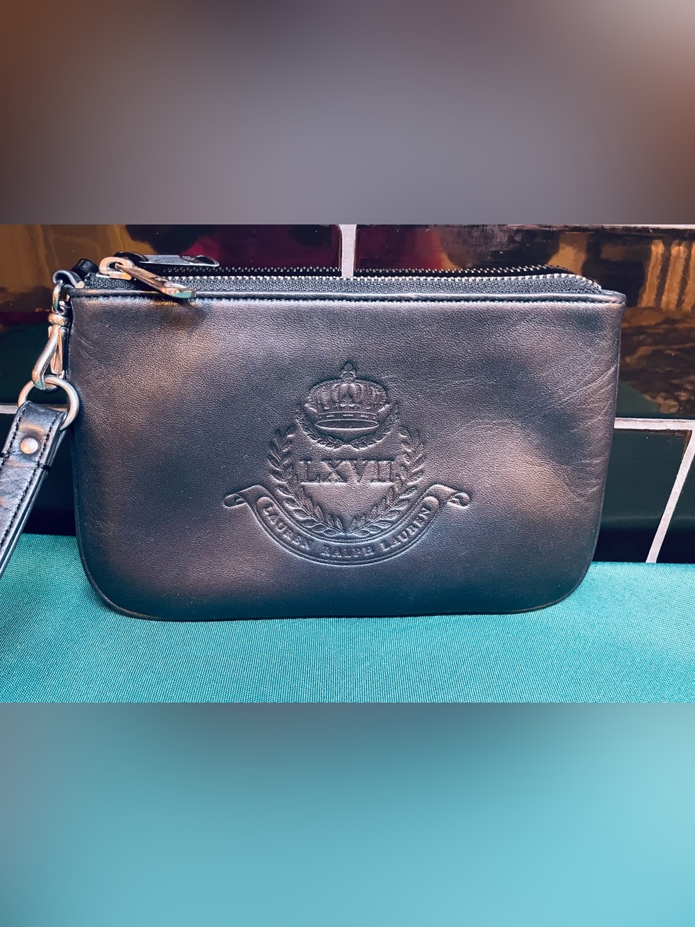 Lovely Ralph Lauren butter soft black leather wristlet with embossed crest.